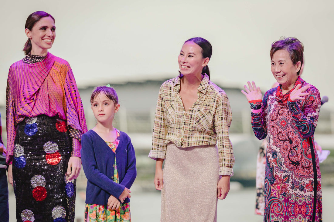 A mother with her young child and an elderly mother with her adult daughter on the fashion runway