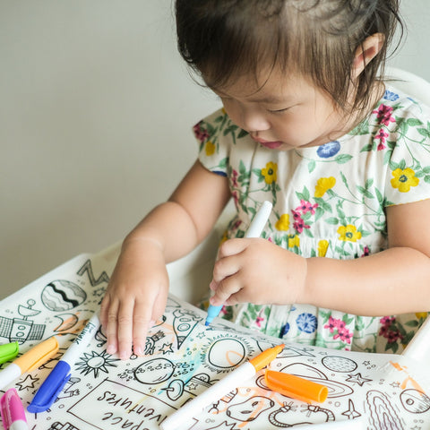 A child enjoying a creative activity by DrawnBy
