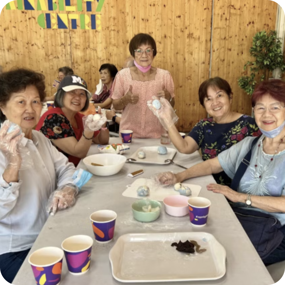 Corporate volunteers engaging beneficiaries through an inclusive community activity